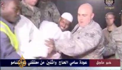 Sami al-Haj being carried off a US military aircraft in Khartoum