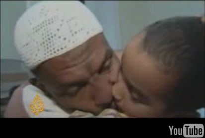 Sami al-Haj hugging and kissing his son