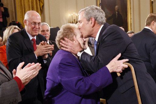 President George W. Bush kisses Arlene Howard on the forehead following his farewell address to the nation Thursday evening, Jan. 15, 2009 in the East Room of the White House. The President met Ms. Howard shortly after Sept. 11, 2001, where she gave him her son's police badge after he perished in the terrorists attacks on the World Trade Center. President Bush still carries the badge with him today as a reminder of all that was lost. - White House photo by Eric Draper